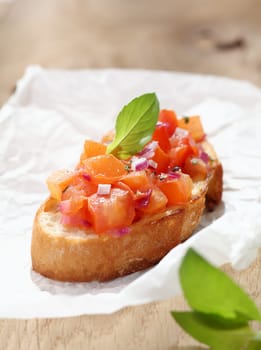 Delicious Italian bruschetta, an antipasti where a variety of toppings are put on toasted or grilled bread, in this instance a mixture of chopped tomato, onion, oil and seasonings on toasted baguette