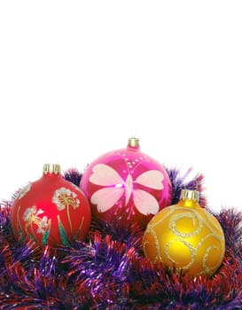 Christmas tinsel and toys on a white background