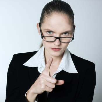 studio shot portrait of one beautiful business strict  nanny teacher woman pointing