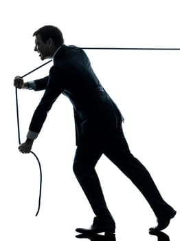 one caucasian business man pulling a rope in silhouette studio isolated on white background
