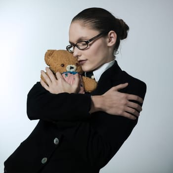 studio shot portrait of one caucasian young woman  holding a teddy bear
