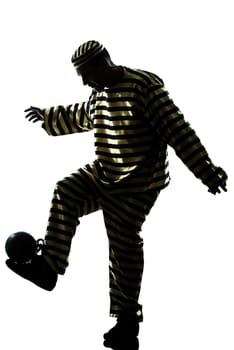 one caucasian man prisoner criminal playing soccer with chain ball in studio isolated on white background