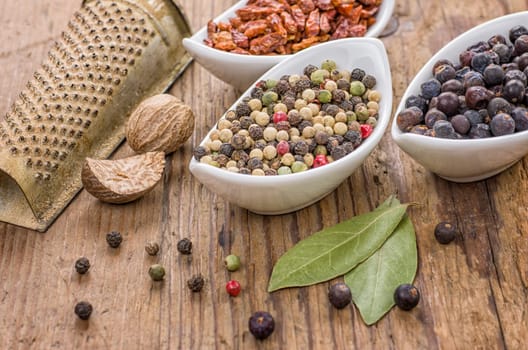 Different spices on a wooden background