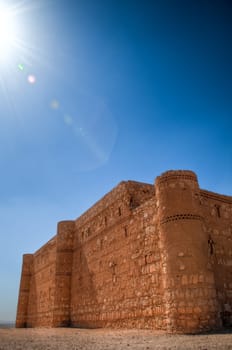 ancient desert castle with blue sky in background in Jordan