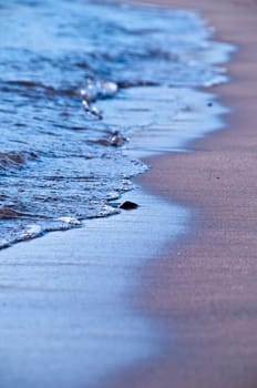 dreamy sea shore with blue waves washing sandy beach