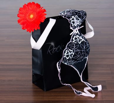photo of the fashion still life with  packet, flower and bra