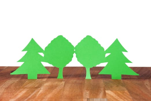 some trees symbolizing wood and forest on a wooden plank, isolated