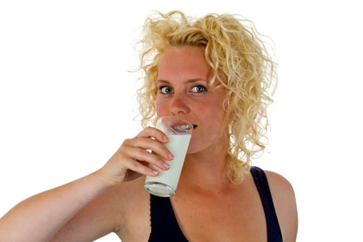 Young woman with a glass of milk isolated on white background