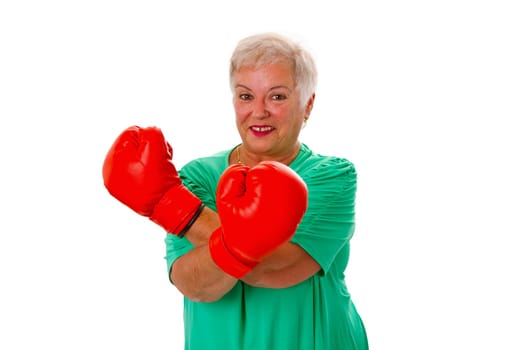 Senior woman with red boxing gloves isolated on white background