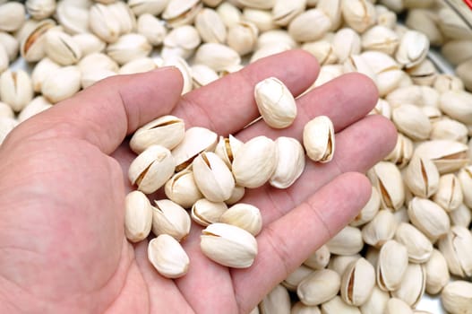 Open hand showing pieces of pistachio nuts
