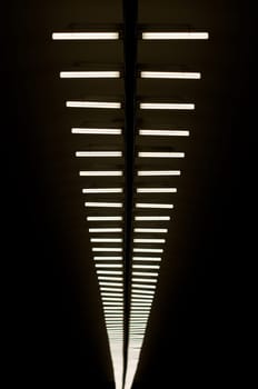 row of lapms on the ceiling of the underground hall
