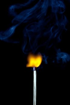 match burning with fire and smoke isolated on black background