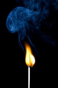 match burning with fire and smoke isolated on black background