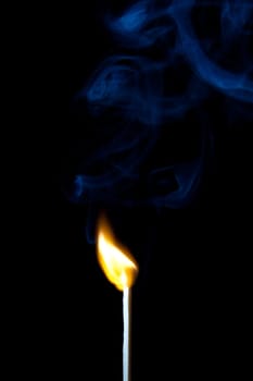 match burning with fire and smoke isolated on black background