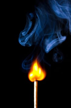 match burning with fire and smoke isolated on black background