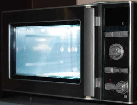 details of modern microwave oven in the kitchen