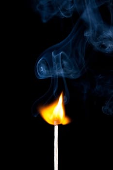 match burning with fire and smoke isolated on black background