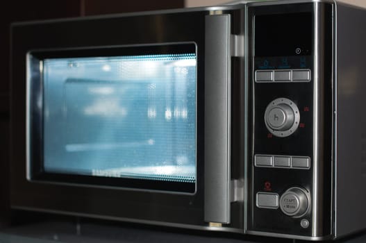 details of modern microwave oven in the kitchen