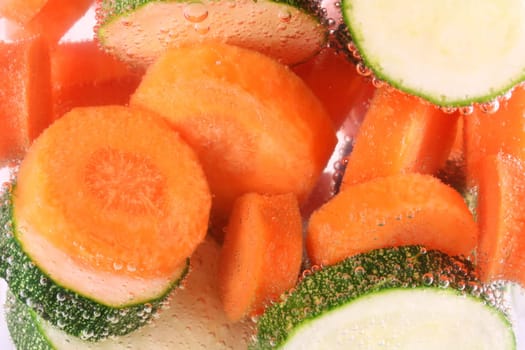 Carrots and courgettes in water cooking