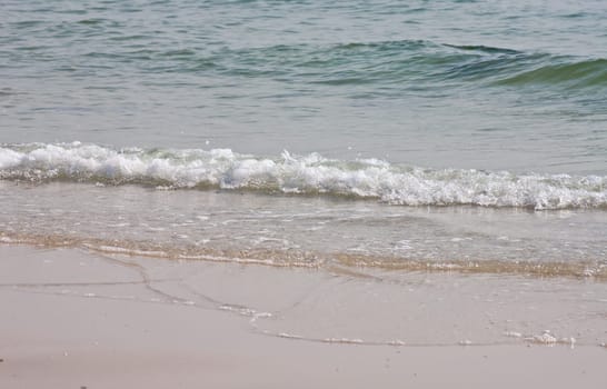 Sea water waving into the beach.