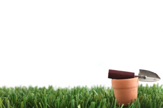 Gardening tools in pots on cut grass