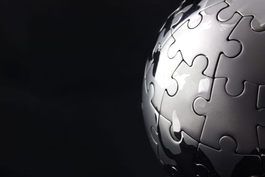 Globe jigsaw half moon on a black background