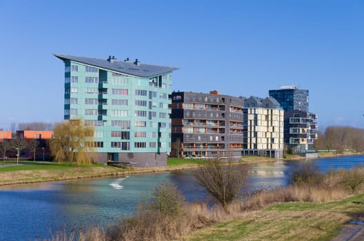 modern apartments along a canal in Almere, Netherlands