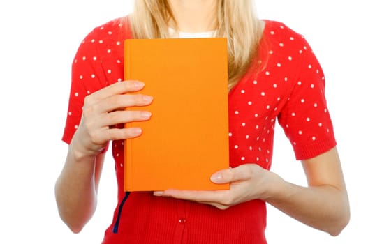 young girl isolated on white background standing with orange book with empty cover in her hands