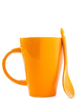 orange empty ceramic cup and spoon isolated on white