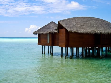photo of the over water bungalow on tropical island of maldives