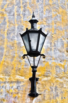 old lantern on yellow wall in street of Tallin old town, Estonia