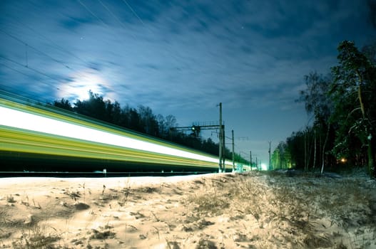 fast moving passenger train in winter night