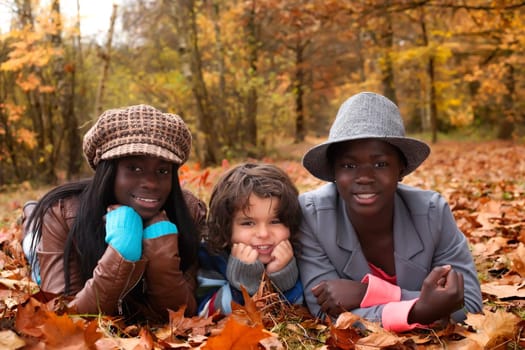 Happy family with foster children in the forest