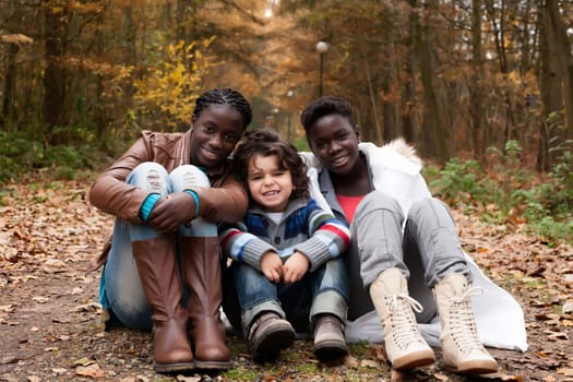 Happy family with foster children in the forest