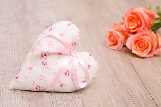 Romantic heart with bow and roses on vintage wood