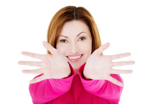 Portrait of excited woman pointing with both hands towards the camera