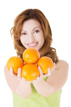 Happy woman with orange fruits, isolated on white