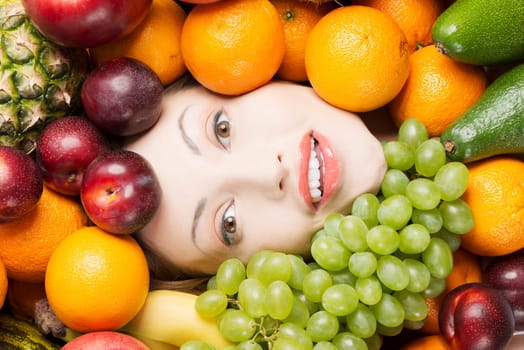 Woman face in fruits, healthy nutrition and diet concept.