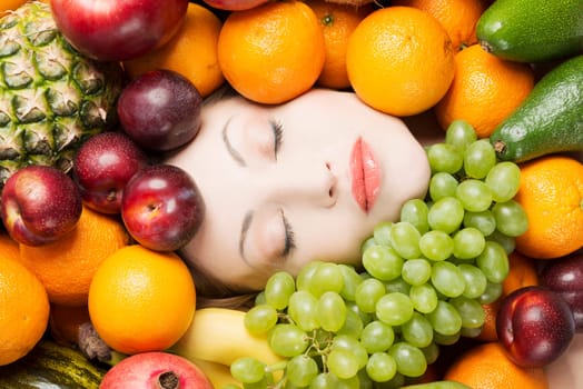 Woman face in fruits, healthy nutrition and diet concept.