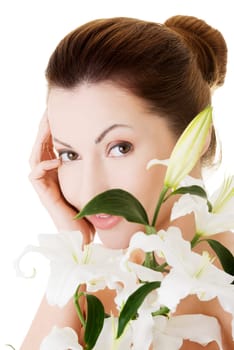Portrait of beautiful adult woman with health skin and with lily flower
