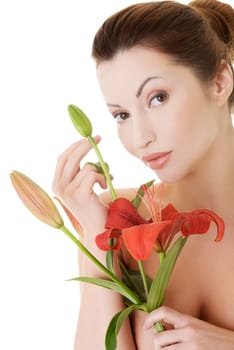 Portrait of beautiful adult woman with health skin and with red lily flower