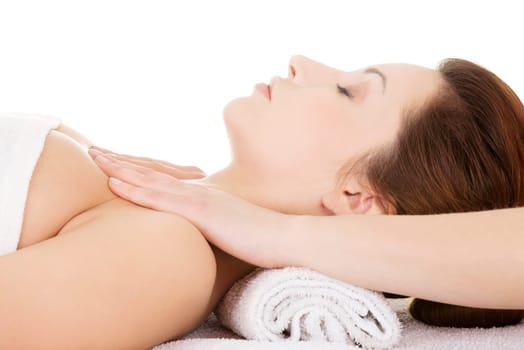 Attractive woman relaxing beeing massaged in spa saloon