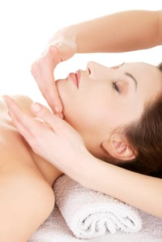 Beautiful young relaxed woman enjoy receiving face massage at spa saloon