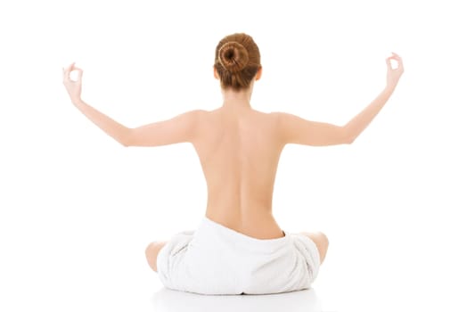 Young beautiful nude woman with towel practicing zoga , isolated on white