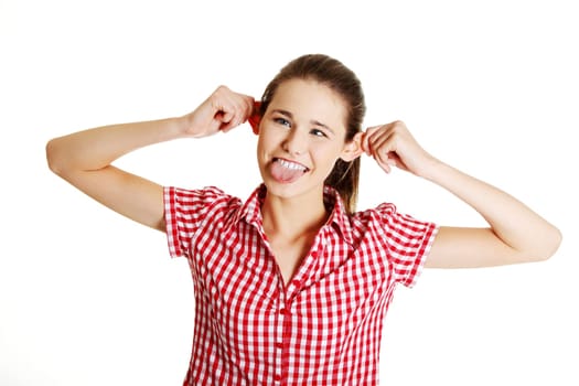 Teen girl making a face to the camera, on white