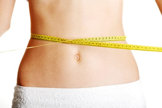 Belly of beautiful young female with measuring tape
