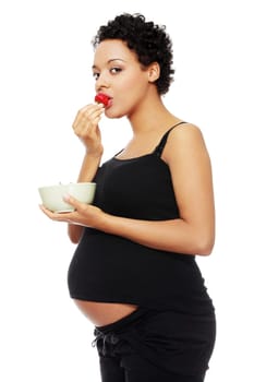 Young happy pregnant afro american woman with strawberries, isolated on white background