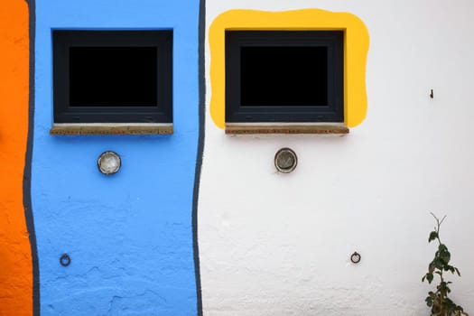 The photograph of a brightly painted house façade.