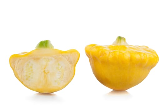 Two Yellow Scallop squash on white background.