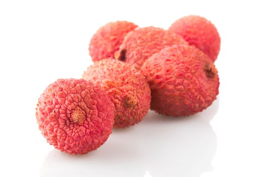 Group of lychee fruit on white with shadows